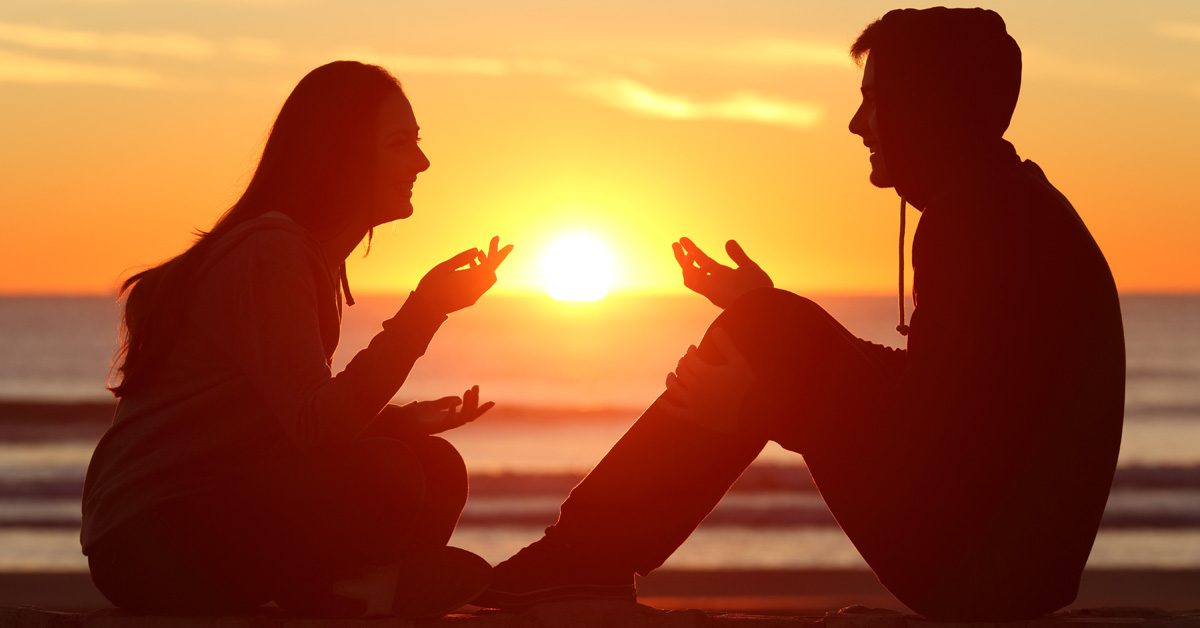 Couple smoking in front of sunset